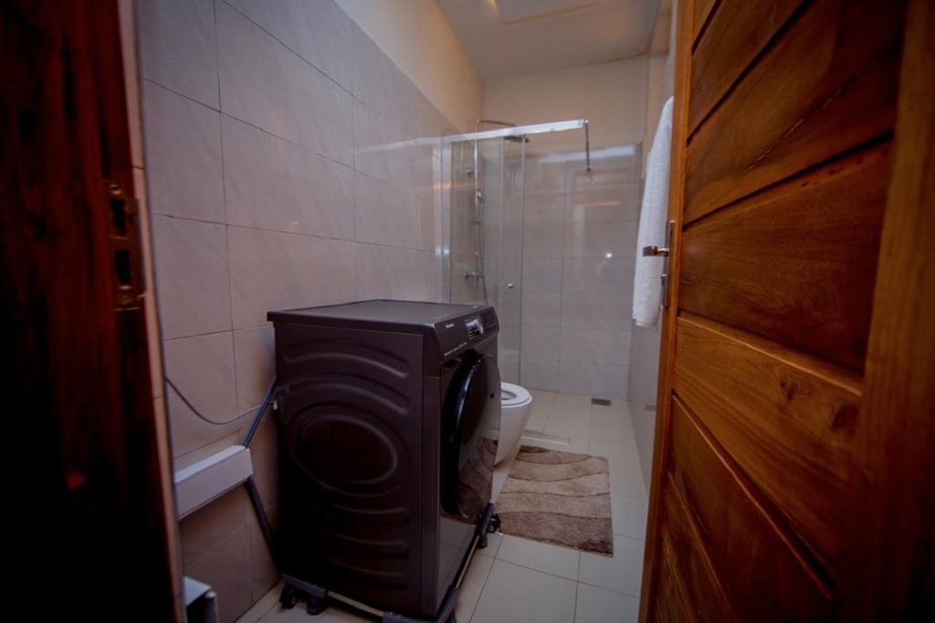Clean Bathroom with Washing Machine & Shower